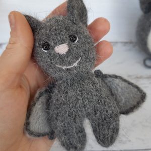 Newborn bat bonnet and stuffed toy bat. Knitted baby photo prop