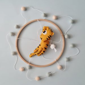 Baby mobile with tiger and pom-poms