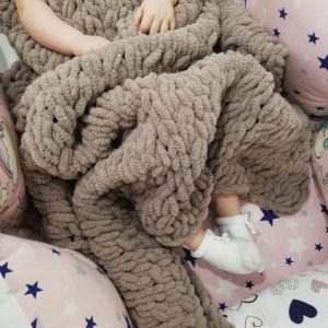 baby under beige blanket