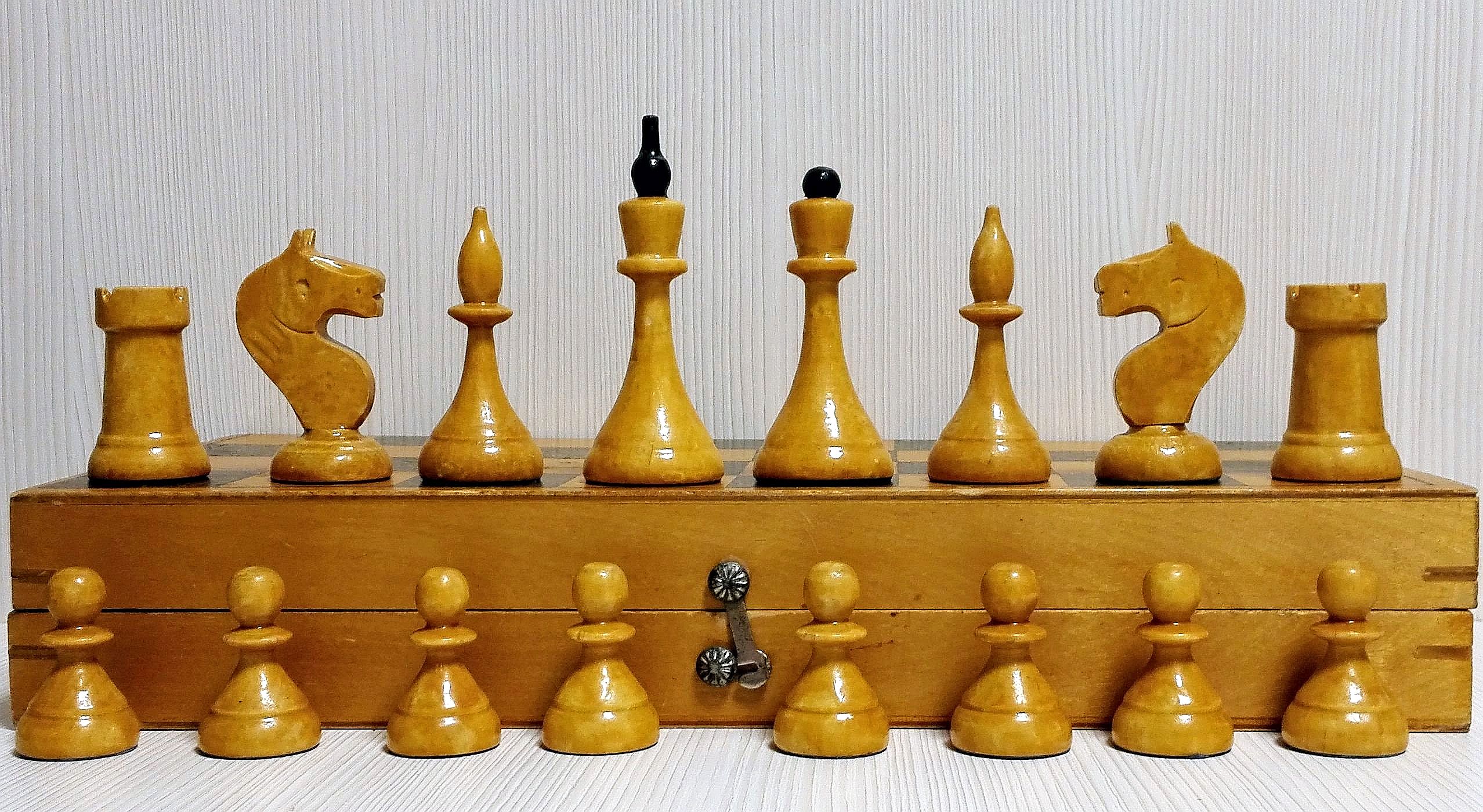 Vintage wooden chess set with queen gambit opening, close-up view