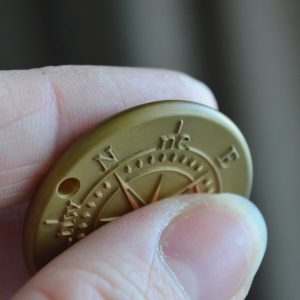 Custom brass pendant with engraved compass