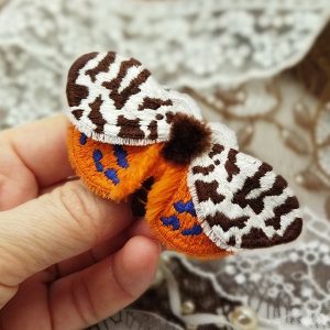 Embroidered butterfly with brown spots