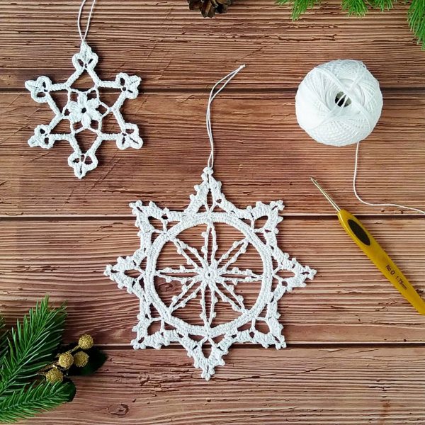 Crochet lace snowflake pattern 2 designs includes detailed instructions with pictures of each step for additional help. These large and small crochet lace snowflakes can be used to decorate your home and Christmas tree. Directions for starching the ornaments are also included.