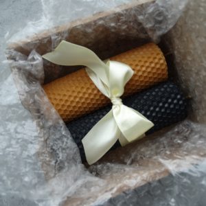 Set of colored candles made of natural wax. Black and gold candles