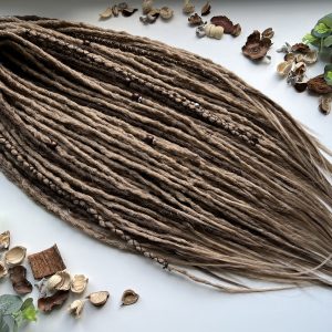 Medium blonde dreads with brown accents. Boho dreadlocks
