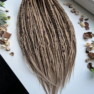 Medium blonde dreads with brown accents. Boho dreadlocks