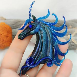 Unicorn brooch on palm