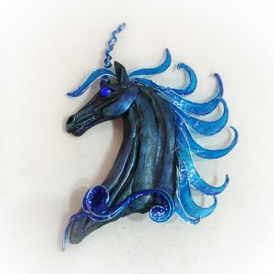 Unicorn brooch on white background