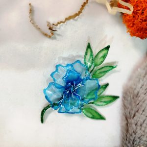 Floral brooch with blue transparent flower