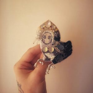 "Sirin Bird" - handmade embroidered brooch with the image of the mythical bird Sirin. Brooch in hands, natural size