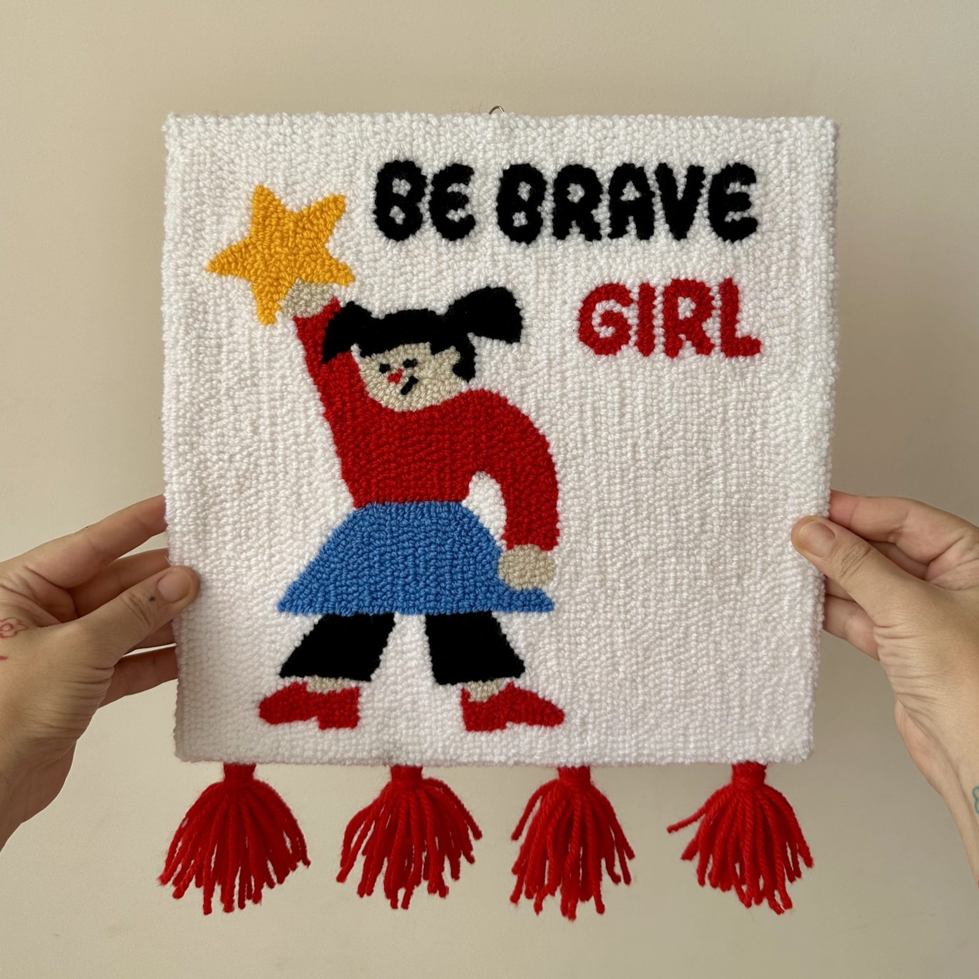 Punch Needle Wall Hanging “Be Brave Girl” Handmade Textile Art 9 “Be Brave Girl” handmade punch needle wall hanging held in hands