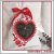 Embroidery design of a heart-shaped window with flowers.